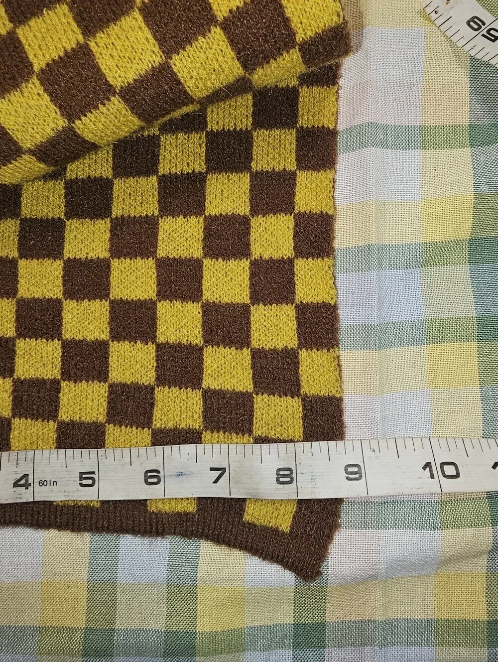 soft knit scarf  brown and mustard yellow checkerboard pattern.